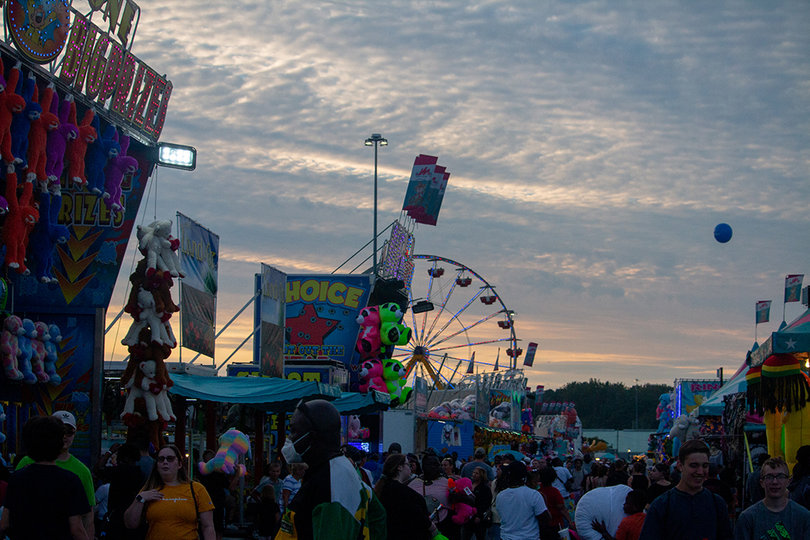 Fairgoers walk throughout the New York State Fair. 