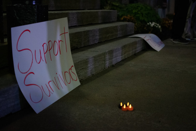 A sign that reads "Support Survivors" remains as the crowd dispersed and went home for the night after hearing the many stories of sexual assault.