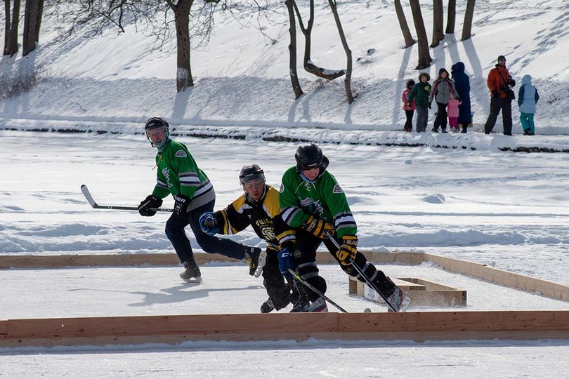 A player blocks their opponent from advancing the score in a morning game at the 2022 Syracuse Pond Hockey Classic. 