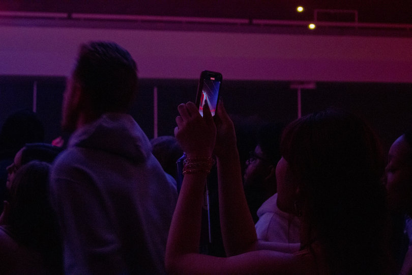 Students record clips of the concert to post on social media and share with friends not in attendance.