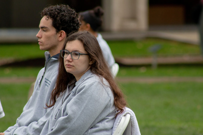 The silence of the cohort fills the quad so the only talking done by passers-by is in hushed whispers. Remembrance Scholars Louis Smith and Taylor Stover reflect on the lives of the students they represent while seated in the silence. 