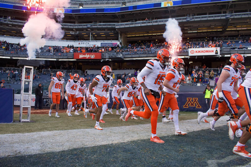 Syracuse takes to the field as fireworks and smoke shoot into the sky. The Orange faced Minnesota in the Pinstripe Bowl on Dec. 29. 