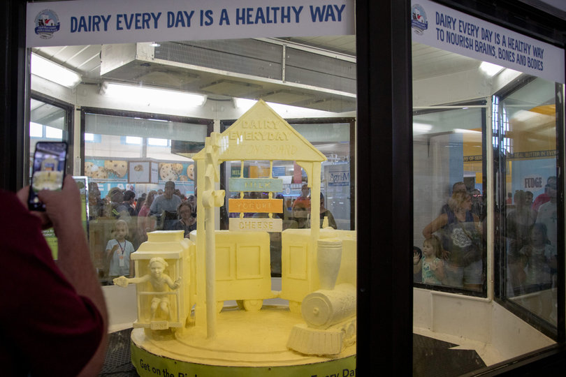 The American Dairy Association North East’s annually changing butter sculpture is a crowd marvel at the NY State Fair. For 2023, the sculpture’s theme was “Dairy Every Day is a Healthy Way – Keeping Kids' Health on Track” and featured a cow and a sign displaying different types of dairy. 
