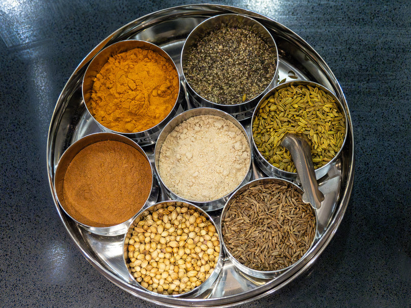 A variety of spices displayed on the kitchen countertop.