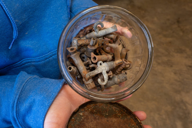 A jar full of old tree taps.