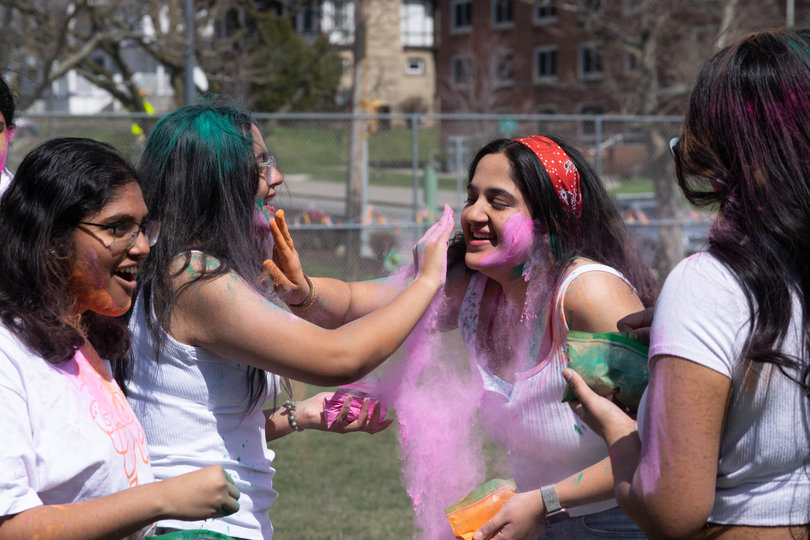 Participants put Holi powder on each other.
