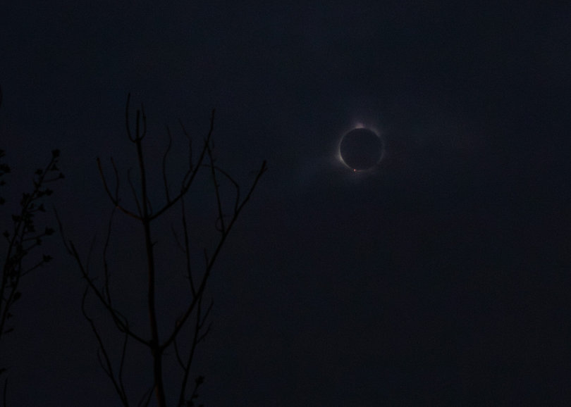 A total solar eclipse, the moon is blocking the sun's light.
