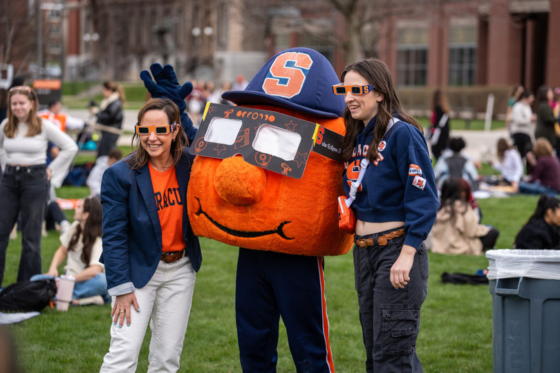 People and a mascot posing for a photo.