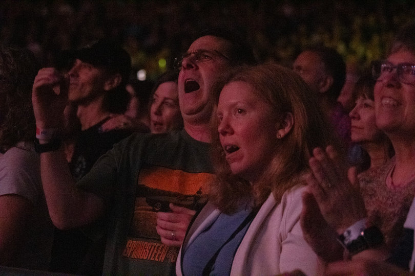 Fans sing passionately in the Dome under dimmed lights