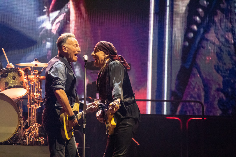 Springsteen and Stevie Van Zandt singing into the same microphone.
