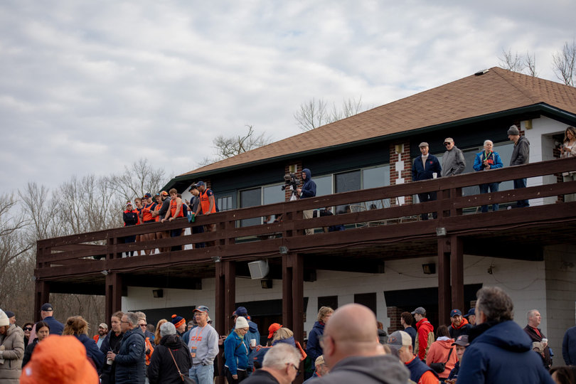 people watching the race from the boathouse