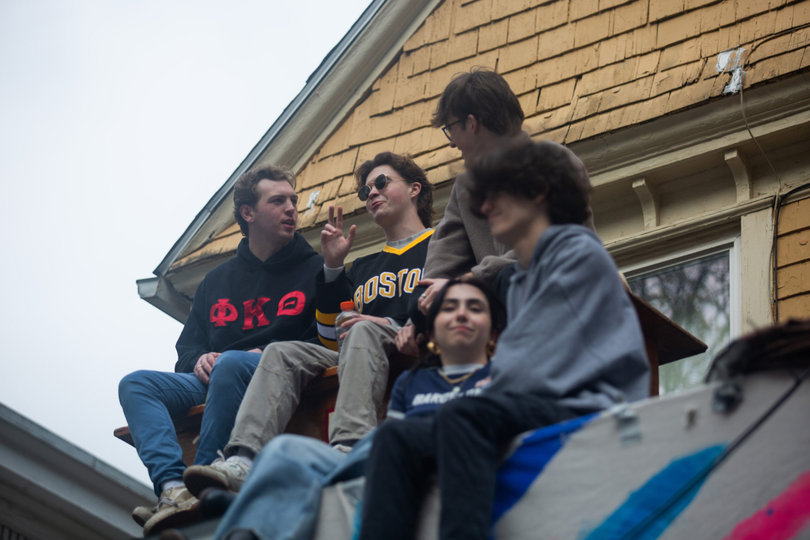 People sitting on a roof chatting