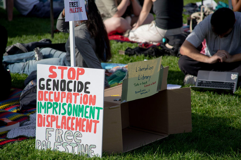 5:39 p.m., April 29, 2024 – Into the evening, more signs are created and displayed. Several of the signs featured some of protestors’ demands for the university. 
