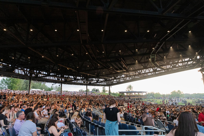 The audience takes their seats at the amphitheater, awaiting the start of Hozier's highly anticipated concert. The show was sold out with crowds filling the covered pavilion and the lawn area. 
