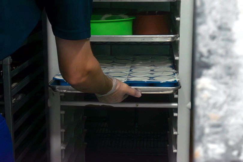ice cream being put into the deep freezer