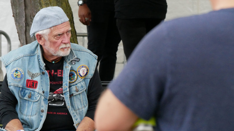 A motorcyclist observes the Syracuse Irish Festival in Clinton Square. He later left the event on his bike.
