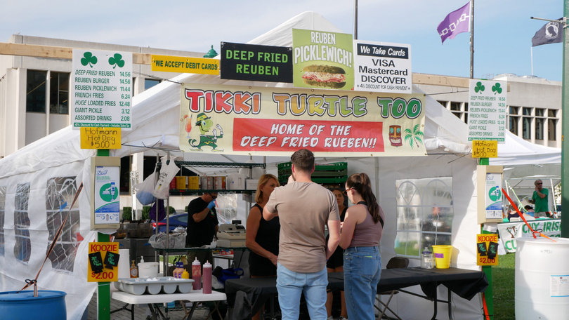 Patrons line up to buy food at one of the various vendor tents and trucks lining Clinton Square. No vendor went a day without attendees’ business.
