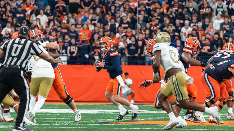 Syracuse quarterback Kyle McCord (middle) drops back to pass, looking to his right for an open receiver. The Ohio State transfer has totaled 735 passing yards in his first two games with the Orange.
