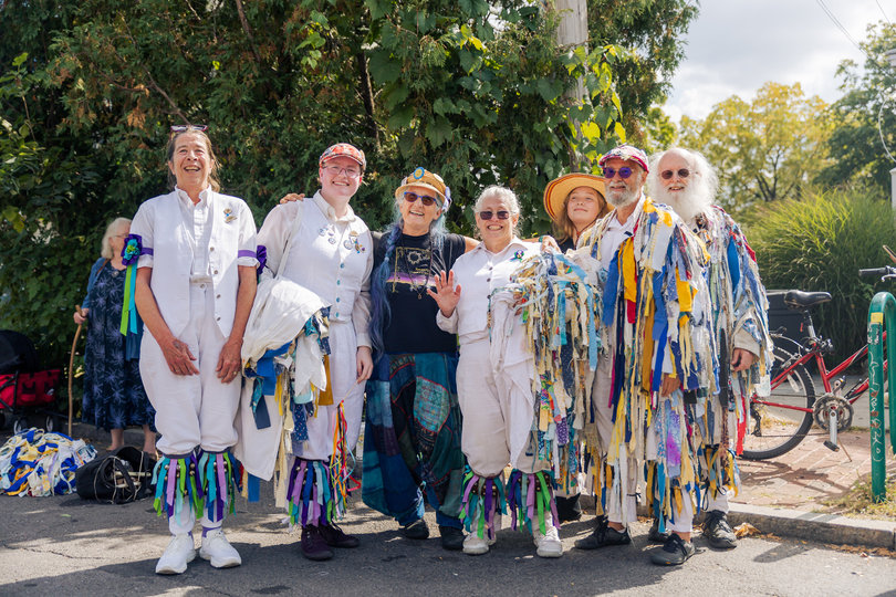 Local dance squad Bassett Street Hounds poses after a street performance. The group invited people of all ages to join in its number.
