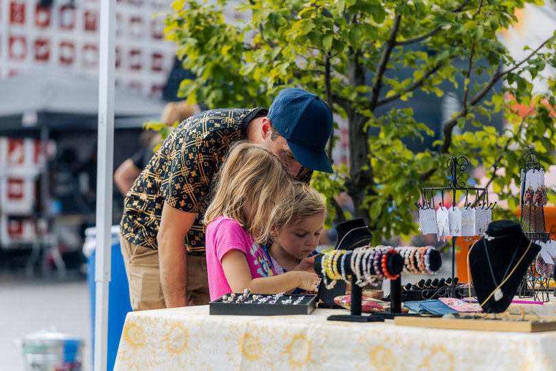 A family explores locally-made jewelry. Many tables featured small businesses with handmade products from Syracuse-based artists.
