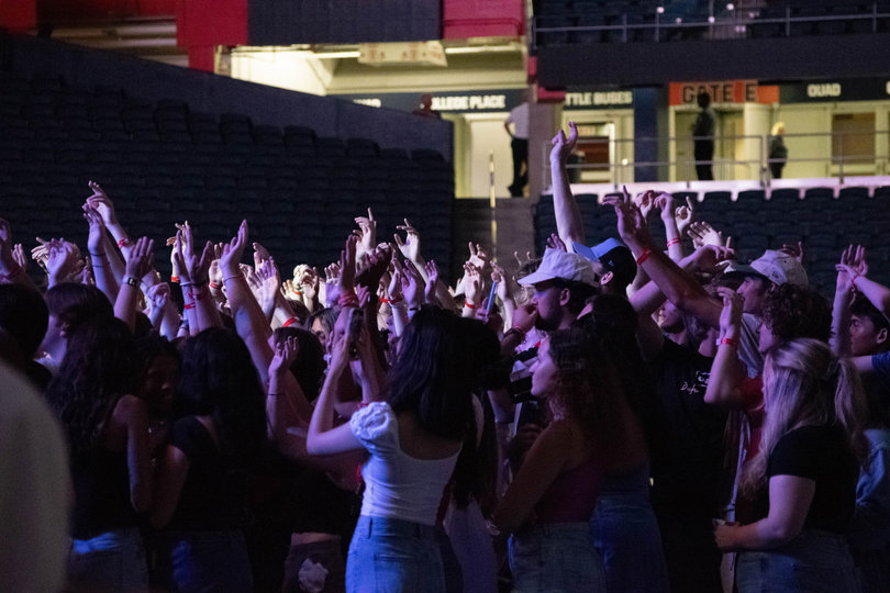 Juice Jam audience members wave their hands in the air during Smino’s performance. This was the first time Juice Jam was open to the public, as well as Syracuse University and SUNY ESF students.