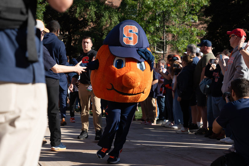 Otto runs toward the JMA Wireless Dome ahead of the Family Weekend football game. Hundreds of SU fans, including both students and parents alike, packed Shaw Quadrangle to attend the quad walk. 
