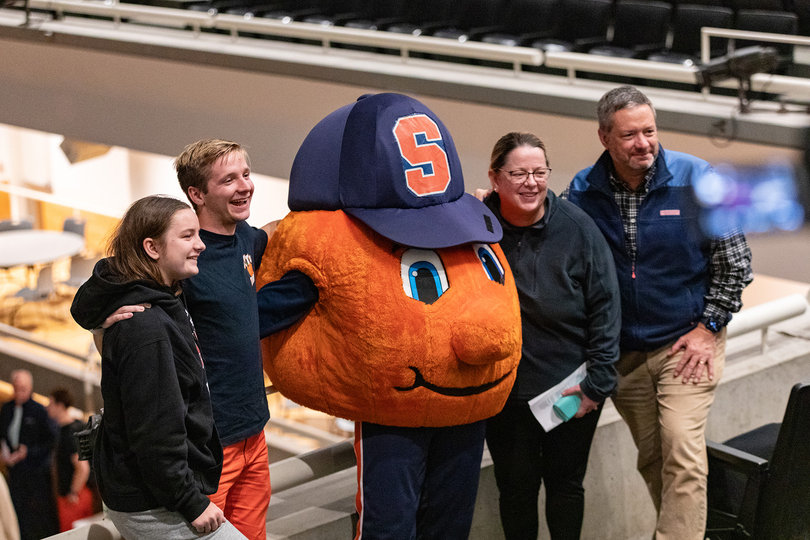 Declan Wavle, a senior member of Otto Tunes, poses for a family photo with Otto the Orange after the Family Weekend a cappella show. Otto Tunes and other groups performed in Schine Student Center’s Goldstein Auditorium.
