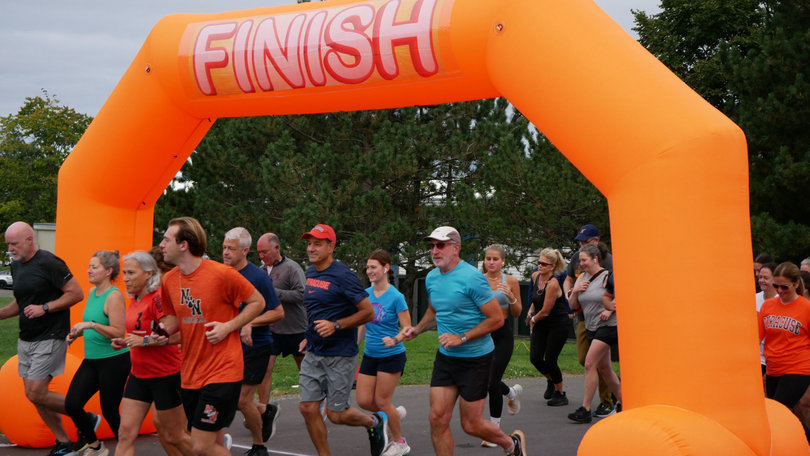 Syracuse University students and families run in the Family Weekend Fun Run on South Campus. Runners completed a total of 2.95 miles. 
