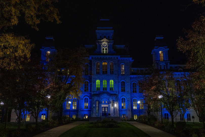 A building with blue light reflecting off of it.