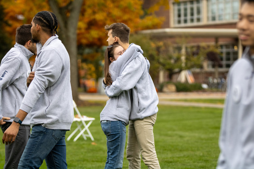 Two people hugging each other.