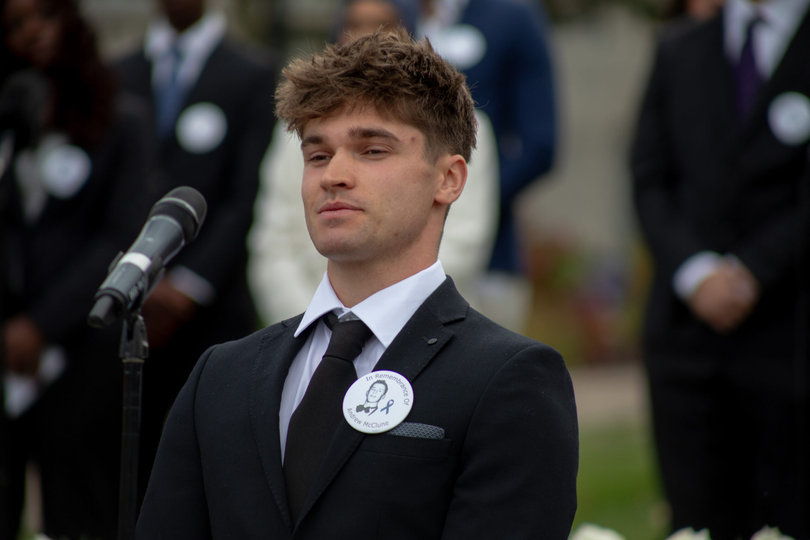 A person standing in front of a microphone.