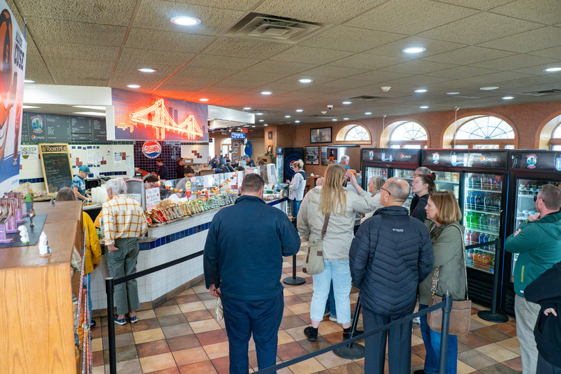 During lunchtime, the Pickle often has long lines for their food. Staff expedite the process, though, to keep the line moving and customers happy.
