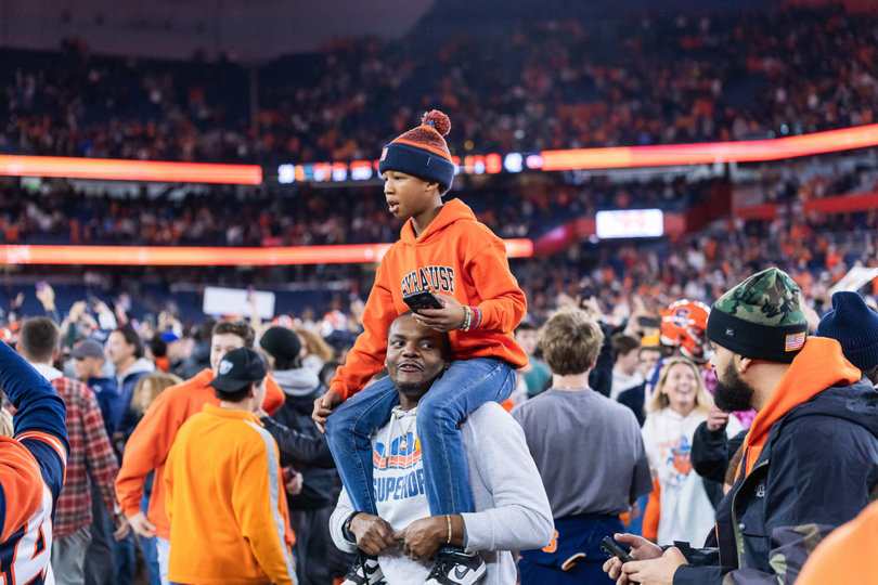 SU fans turn jubilant after the Orange’s triumph over the Hurricanes. It was the first time fans rushed the JMA Wireless Dome field for a football game since 2022, when then-No. 18 Syracuse upset then-No. 15 NC State.
