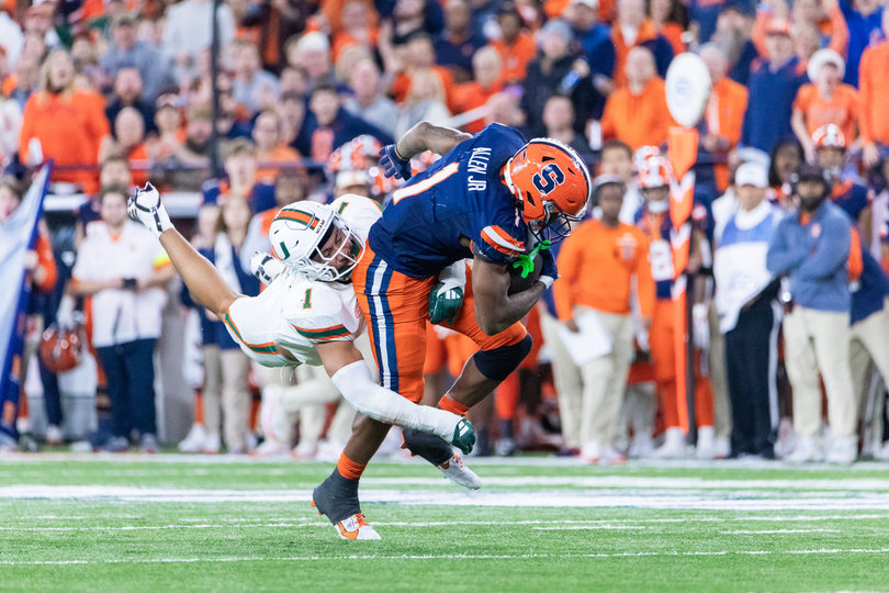 Running back LeQuint Allen Jr. fights through a tackle attempt by Miami linebacker Francisco Mauigoa. Allen Jr. recorded 143 all-purpose yards and two rushing touchdowns in Syracuse’s victory.