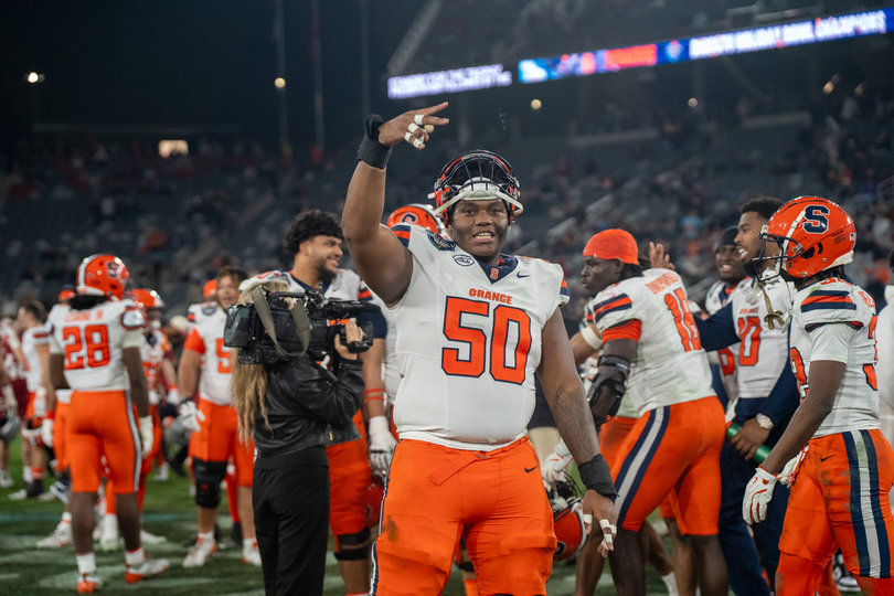 SU center J’Onre Reed celebrates postgame with a hand gesture pointed toward the crowd. Reed played 36 snaps Friday, capping his second season at Syracuse with a Holiday Bowl victory.