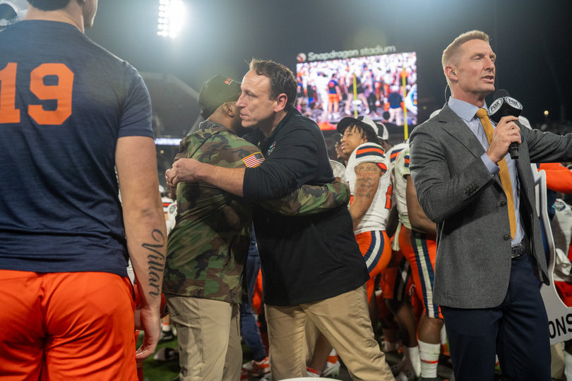 SU head coach Fran Brown shares a hug with world-famous American competitive eater Joey Chestnut. Chestnut served as the “Chief Eggnog Official” at the 45th annual Holiday Bowl. 