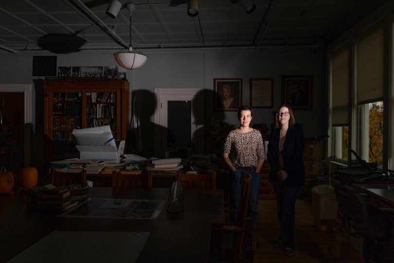 Steph Adams (left) and Amie Flanigan (right) do their work in the Erie Canal Museum’s Buchanan Library. Flanigan did further research into her ancestors who are believed to be haunting the space.