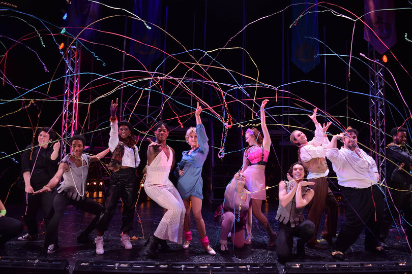 The cast of Head Over Heels poses under streamers at the end of their finale number. The play tells the story of a royal family’s trials and tribulations.