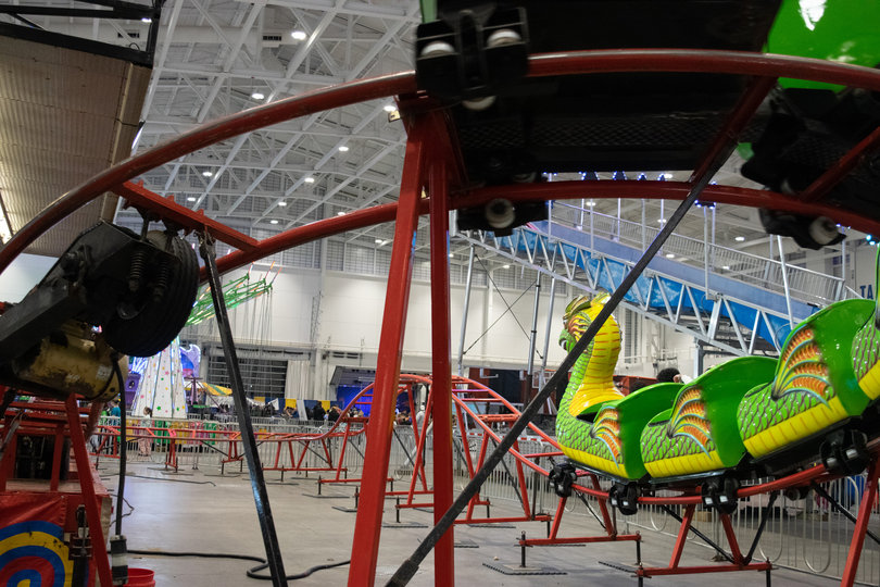 A dragon roller coaster captures the attention of children and adults alike. Shrieks could be heard as people enjoyed the thrill of the ride. 