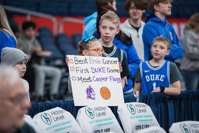 A young Duke fan holds up a sign pregame in hopes of getting Blue Devils’ star freshman Cooper Flagg’s attention. The total attendance for the contest was 23,313, according to SU Athletics.