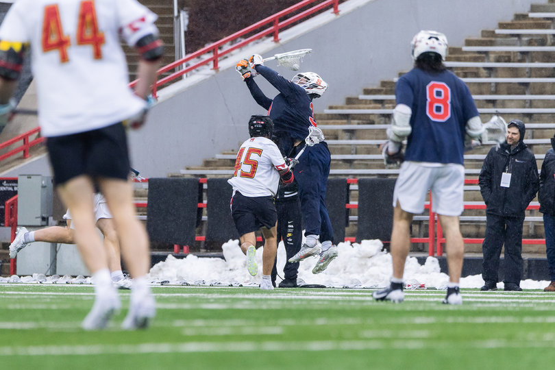 Syracuse goalie Jimmy McCool is caught out of position attempting to clear while Maryland attacker Daniel Kelly (pictured, No. 45) tries to force a turnover. McCool finished SU’s loss to UMD with 12 saves and 11 goals allowed after starting the game 4-of-4 on shot attempts. 