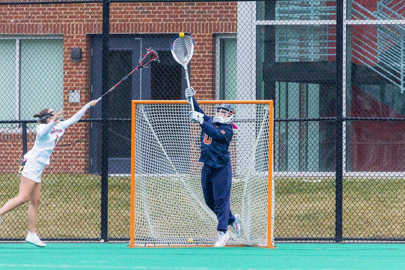 Syracuse goalie Daniella Guyette (No. 0) clears the ball from her own net as Terrapins attacker Maisy Clevenger (No. 1) reaches out to defend the ensuing pass. Guyette was stellar in her second career start, stopping 11-of-20 shot attempts for a .550 save percentage. 
