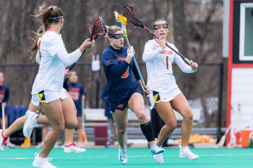 Syracuse freshman Lexi Reber (middle) races through a crowd of Terrapins as Maryland’s Maisy Clevenger (No. 1) closes in from behind. Reber has slotted into the starting lineup in each of her first two college games, solidifying a new-look group for the Orange.