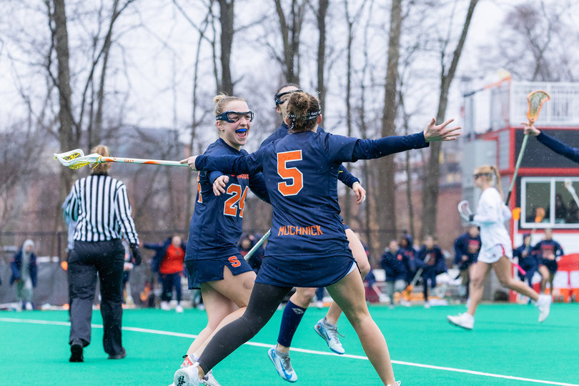 Syracuse trio Emma Muchnick (No. 5), Caroline Trinkaus (No. 24) and Alexa Vogelman (No. 11) rejoice after another score for the Orange. SU captured its first top-10 victory of the season by taking down No. 7 Maryland in College Park.