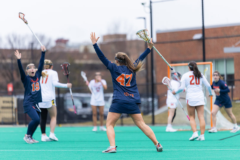 SU freshman Mileena Cotter (No. 47) raises her hands in celebration, much to the amazement of attacker Gracie Britton (No. 19), after Cotter slotted home a shot-clock-beating goal from distance. Cotter’s score, her fourth of the season, pushed SU’s lead to 11-6.
