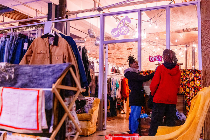 Customers rifle through the racks while shopping for clothes at The Cherry Pit, a local vintage store in Syracuse. The shop closed its doors at the end of the month.