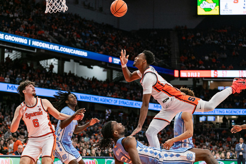 Syracuse men’s basketball guard J.J. Starling attempts an acrobatic layup through contact from North Carolina forward Jae’Lyn Withers during the Orange’s Feb. 15 matchup against the Tar Heels. Starling tallied 22 points in the contest despite SU falling to UNC 88-82.
