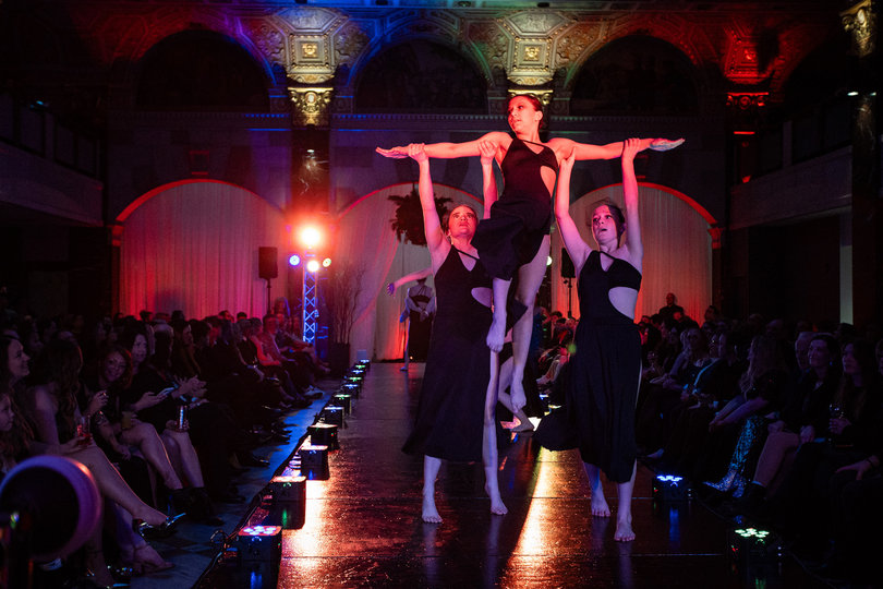 Artistic Designs Dance Company performed an opening dance. Dancers lifted each other into the air while dancing in unison to haunting instrumental music.