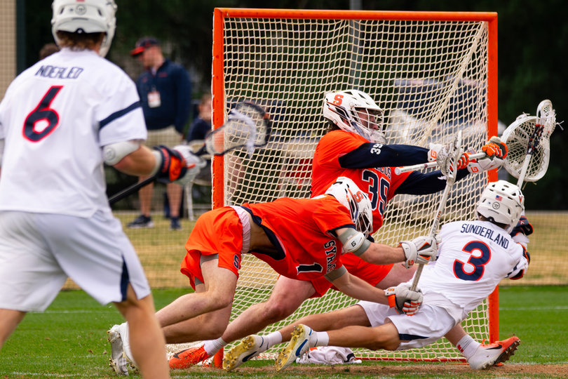 Goalie Jimmy McCool nearly does the splits while denying a diving shot opportunity from Virginia attack Truitt Sunderland. Sunderland, the Cavaliers’ leading scorer, was held to just two points Saturday while being guarded by Syracuse defenders like Riley Figueiras, Billy Dwan III and Nick Caccamo.
