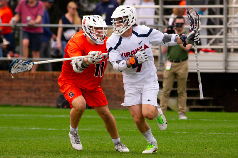 Junior long pole Riley Figueiras (left) forces Virginia’s attack McCabe Millon (right) inside while face guarding him. Figueiras often drew Millon as his assignment Saturday, though he allowed the star sophomore to unleash a six-point day (three goals, three assists) against Syracuse.